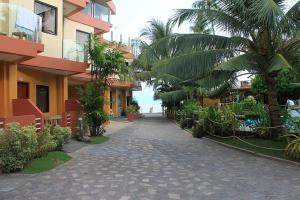 a street in a resort with palm trees and buildings at Lost Horizon Beach Dive Resort in Panglao Island