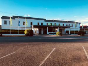 
a large building with a parking lot on the side of the road at ibis Styles Broken Hill in Broken Hill
