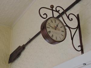 a clock hanging from the side of a wall at Dunkeld Old Bakery Accommodations in Dunkeld