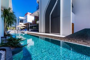 a swimming pool in the middle of a building at Wintree City Resort Chiang Mai in Chiang Mai