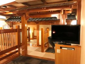 a living room with a flat screen tv and a entertainment center at Pal Annex Katsuyama (Love Hotel) in Miyakomachi