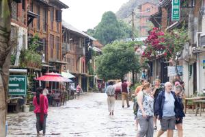 a group of people walking down a street at Bandipur Kaushi Inn in Bandīpur