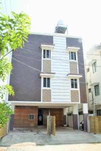 a white building with a black roof at ComfortWings in Coimbatore