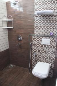 a bathroom with a toilet and a shower at ComfortWings in Coimbatore