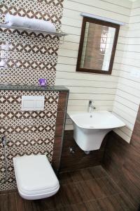 a bathroom with a sink and a toilet at ComfortWings in Coimbatore