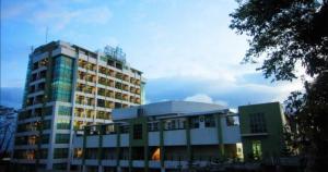 a large building in front of a building at One Tagaytay Place Hotel Suites OFFICIAL ACCOUNT in Tagaytay