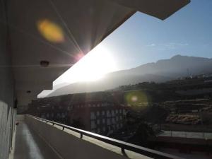 a view of the sun from a balcony of a building at Cozy Apartment in Candelaria