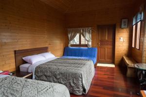 Säng eller sängar i ett rum på Ruyi Yuan Homestay
