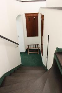 a stairway with a wooden door and a bench at Penzion U Karla IV. in Kadaň