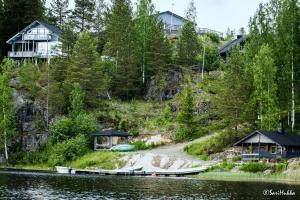 a group of houses on the side of a lake at Rämäkkä Holidays in Rautalampi