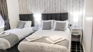 a bedroom with two beds with towels on them at Number 4 in Derry Londonderry