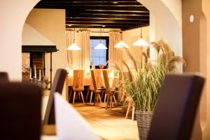 a living room with a table and chairs and a dining room at Landhotel Laudersbach in Altenmarkt im Pongau