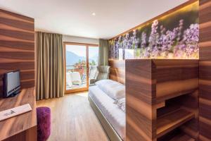 TV a/nebo společenská místnost v ubytování Marini's giardino Hotel