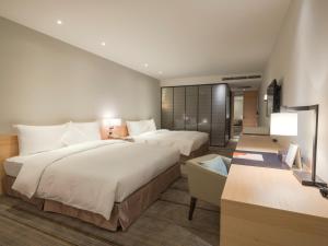 Postel nebo postele na pokoji v ubytování Hotel COZZI Zhongshan Kaohsiung