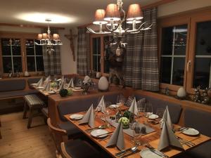 a large dining room with a long table with chairs at Gasthaus Moosegg in Lochau