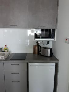 A kitchen or kitchenette at P.L Hermes Studios & Apartments