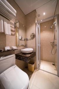 a bathroom with a toilet and a sink and a shower at Nam Keng Hotel Penang in George Town