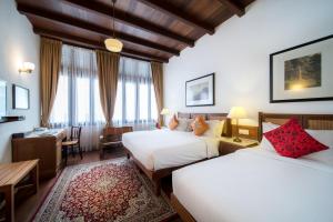 Säng eller sängar i ett rum på Nam Keng Hotel Penang