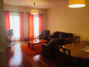 una sala de estar con un sofá y una mesa en Estacada Apartment, en Machico
