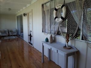 a living room with a lifesaver hanging from the wall at Bay Bell Cottage in Saint Leonards