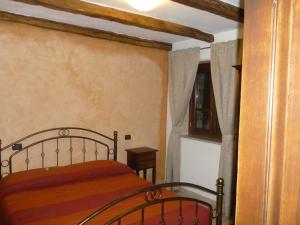 a bedroom with a bed and a window at Fattoria Sos Astores in Fonni