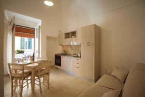 a kitchen with a table and a dining room at Palazzo Rattazzi in Monopoli