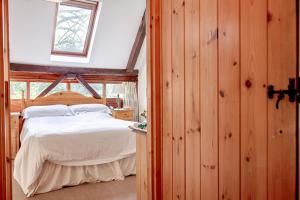 a bedroom with a bed in a room with wooden walls at The Grove Cromer in Cromer