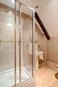 a bathroom with a shower and a sink at The Grove Cromer in Cromer