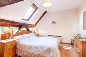 a bedroom with a white bed and a window at The Grove Cromer in Cromer
