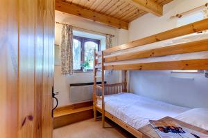 a bedroom with two bunk beds and a window at The Grove Cromer in Cromer