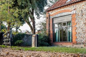 a brick building with a window on the side of it at The Grove Cromer in Cromer