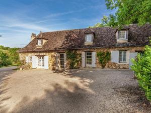 an old stone house with a driveway in front of it at Sprawling Mansion in Aquitaine with Swimming Pool in Campsegret