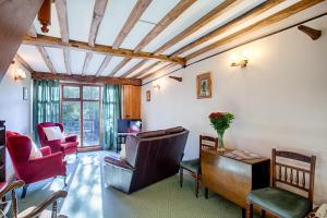 a living room with a couch and a table and chairs at The Grove Cromer in Cromer