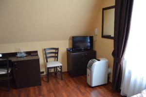 a room with a desk and a tv and a table and chair at Комплекс Спасатель in Kartino
