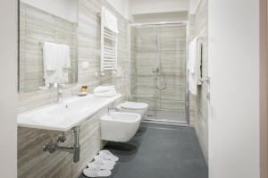 a bathroom with a sink and a toilet and a shower at Genova46 Suites & Rooms in Genova +55 photos
