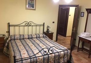 a bedroom with a bed and a table and a door at Il renaiolo in Spello