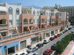 a city street with cars parked in front of buildings at AZAHARA 20 in Nerja