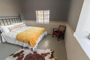 Кровать или кровати в номере Volmoed Cottage