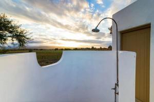 a white refrigerator with a street light next to a garage at Volmoed Cottage in Oudtshoorn