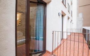 a balcony with a sliding glass door on a building at Yeah Barcelona Hostel in Barcelona
