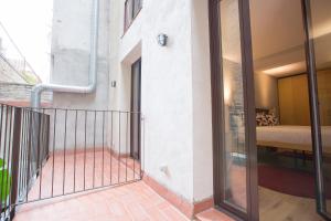 a room with a balcony with a bed and a window at Yeah Barcelona Hostel in Barcelona