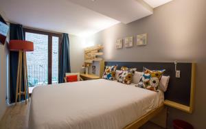 a bedroom with a large bed with pillows at Yeah Barcelona Hostel in Barcelona