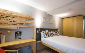 a bedroom with a bed and a wooden cabinet at Yeah Barcelona Hostel in Barcelona