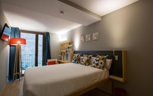 a bedroom with a large bed with pillows at Yeah Barcelona Hostel in Barcelona