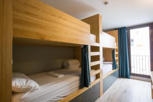 a room with bunk beds with a window at Yeah Barcelona Hostel in Barcelona