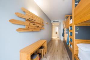 a dorm room with a wooden desk and bunk beds at Yeah Barcelona Hostel in Barcelona