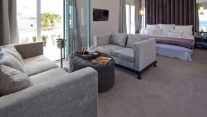 a living room with a couch and a bed at Hotel MiM Ibiza & Spa - Adults Only in Ibiza Town