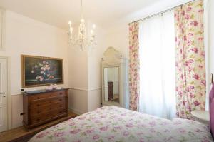 a bedroom with a bed and a dresser and a mirror at Apartments In Pistoia in Pistoia