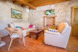 a living room with two couches and a table at Villa Medvidići in Rajki
