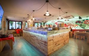 a restaurant with a large wooden bar in the middle at Yeah Barcelona Hostel in Barcelona